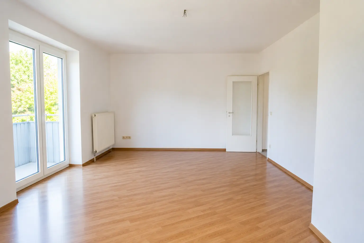 Helles Zimmer mit Balkontür einer von Fuhrmann Immobilien betreuten Immobilie in Saarbrücken